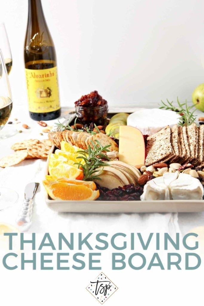 Pinterest image of Thanksgiving Cheese Board, featuring the cheeseboard, served with Vinho Verde wine, the cheese board and Pinterest text