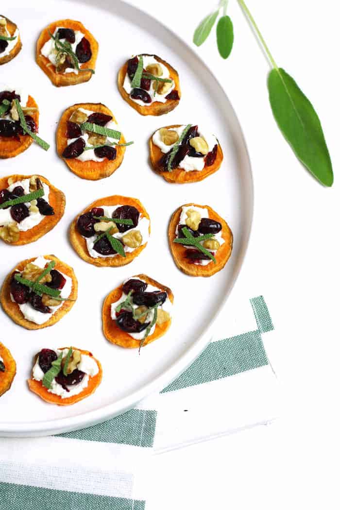 Overhead of several Holiday Sweet Potato Toast Bites sitting on a round white platter