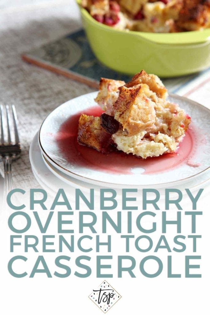 A serving of Cranberry Overnight French Toast sits on a white plate, covered in cranberry syrup, with Pinterest text