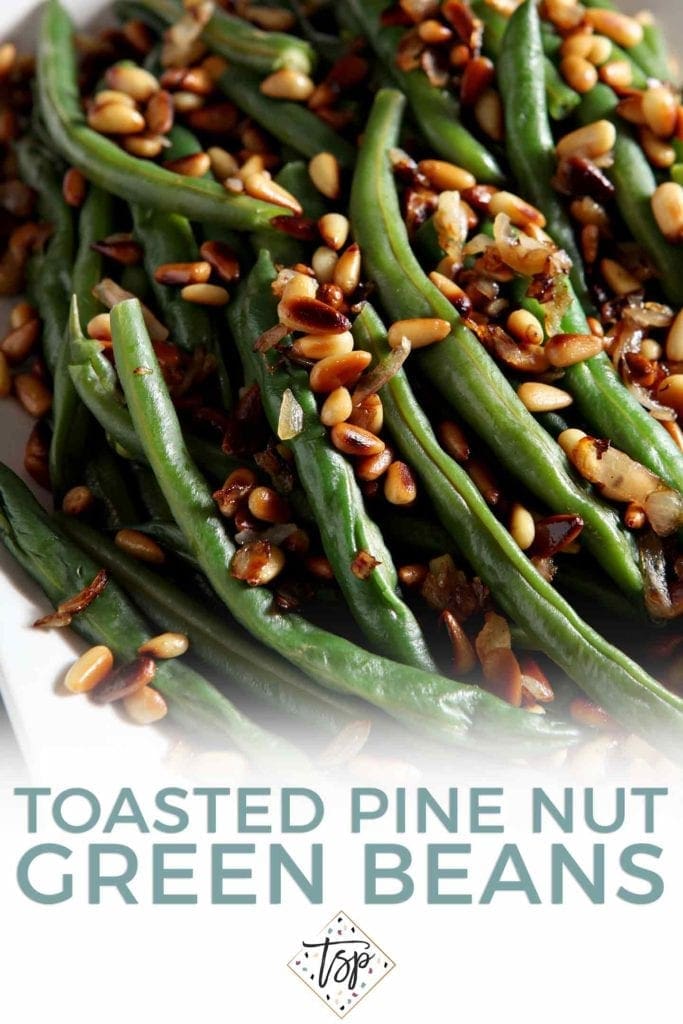 Pinterest graphic for Toasted Pine Nut Green Beans, featuring a close up of the final dish on a white plate