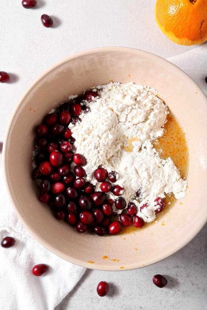 Overhead image of Vegan Orange Cranberry Muffin batter, unmixed, in a mixing bowl