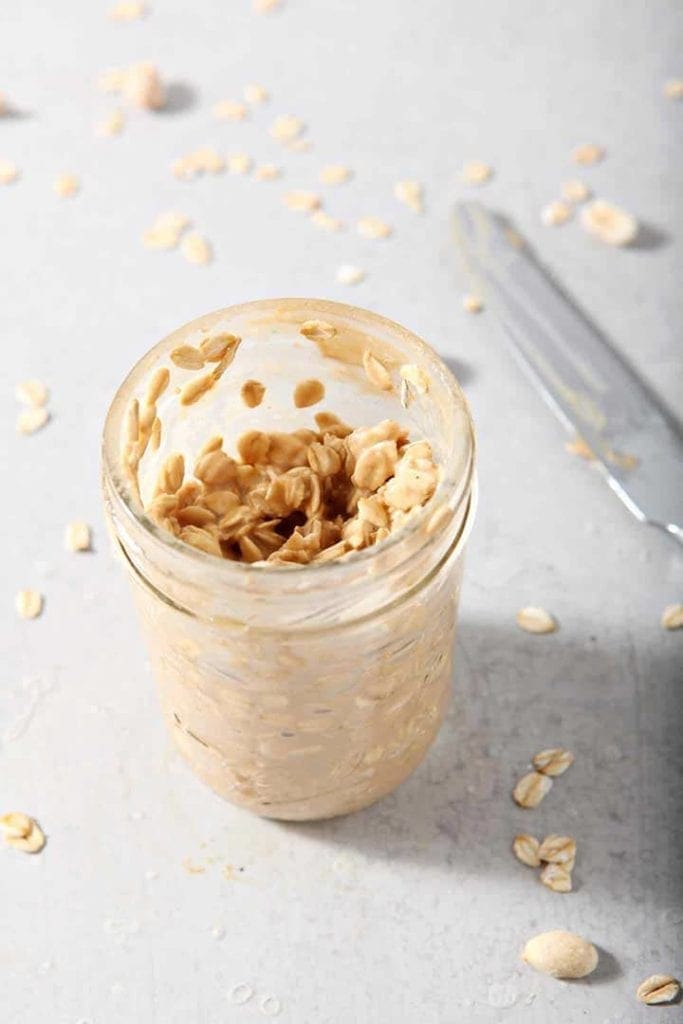 Rolled oats mixed with peanut butter in a mason jar