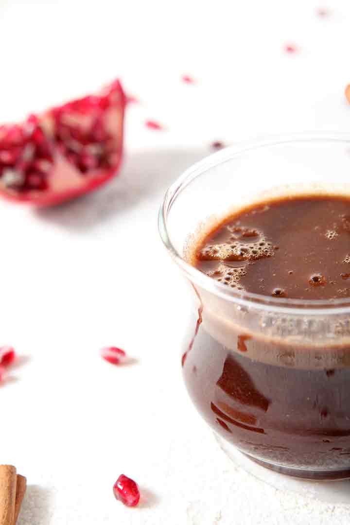 Close up of a glass of Pomegranate Hot Buttered Rum