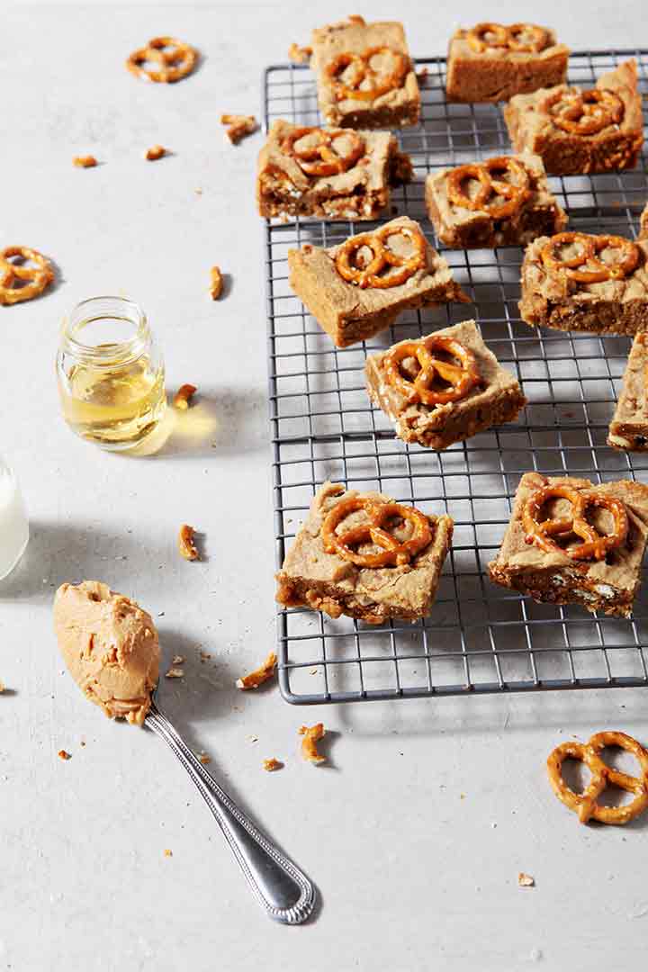 Boozy Bacon Pretzel Peanut Butter Bars cool on a wire rack