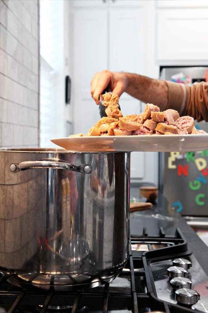 The meats for Chicken and Sausage Gumbo are dropped into the gumbo pot