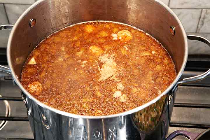 A pot of gumbo simmers on the stovetop