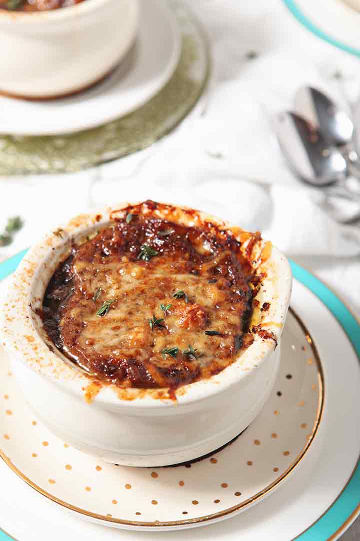 Close up of Instant Pot French Onion Soup in a crock after broiling