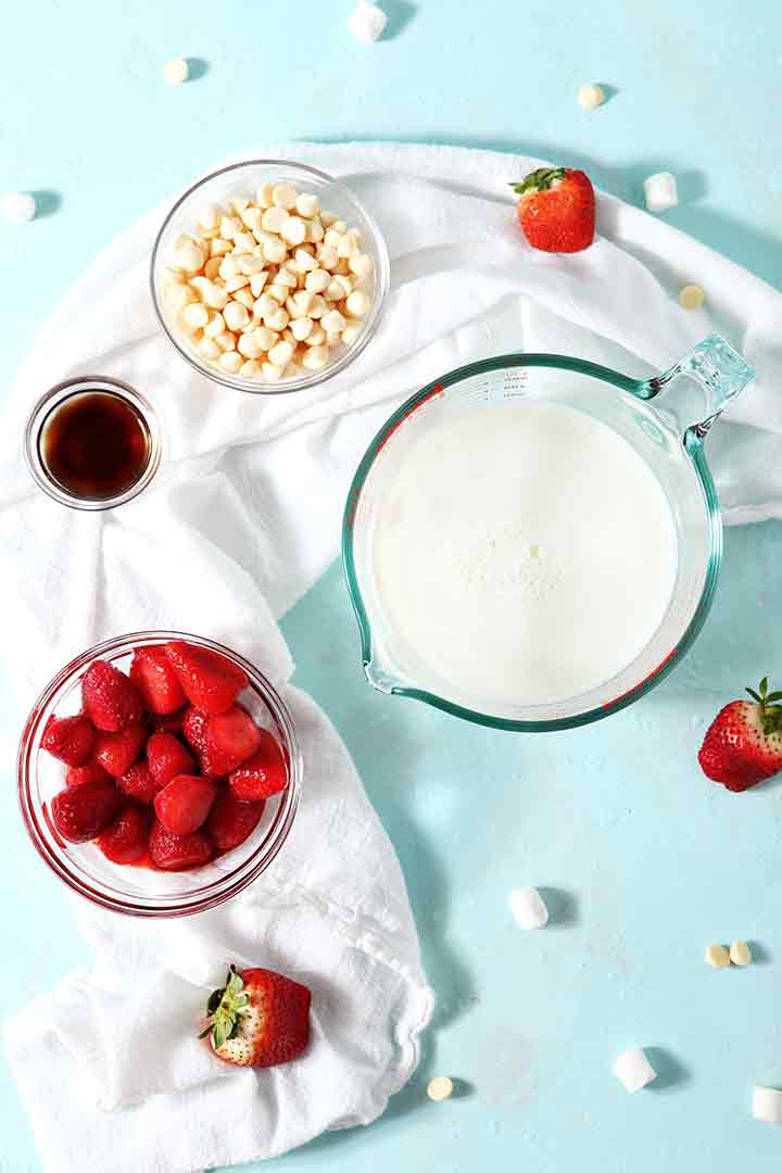 Ingredients for Strawberry White Hot Chocolate on a turquoise background