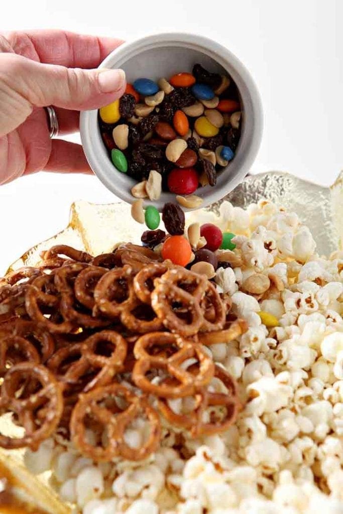 Trail mix is added to the bowl