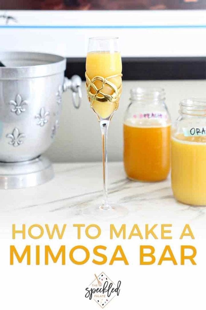 A mimosa sits on a marble slab at a home bar at a home brunch