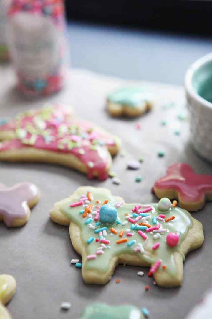 Decorated Lemon Tea Cake Cookies sit on wax paper, cooling