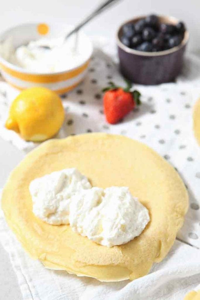 Lemon Whipped Cream is shown in a homemade crepe before fruit is added