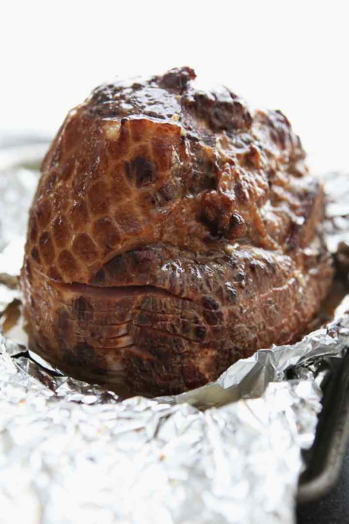 A ham after being glazed and before baking longer