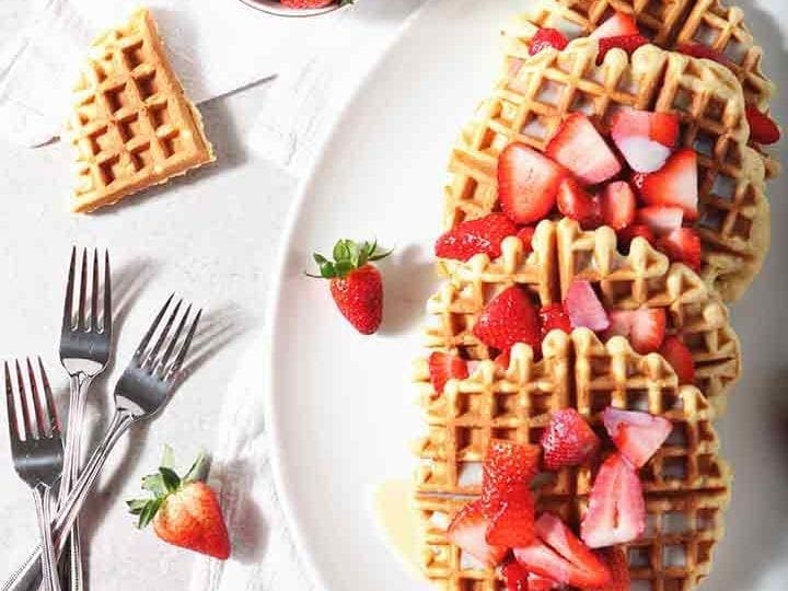Homemade Waffles with Strawberries and Cream are served on a platter
