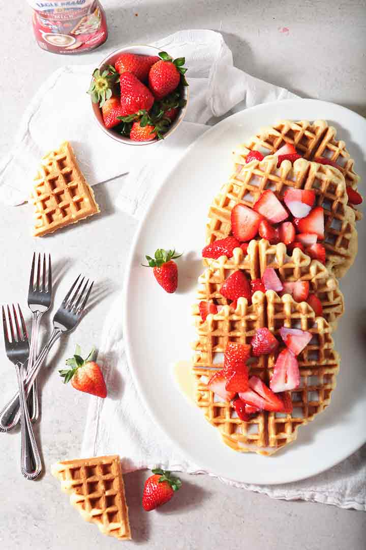 Homemade Waffles with Strawberries and Cream are served on a platter