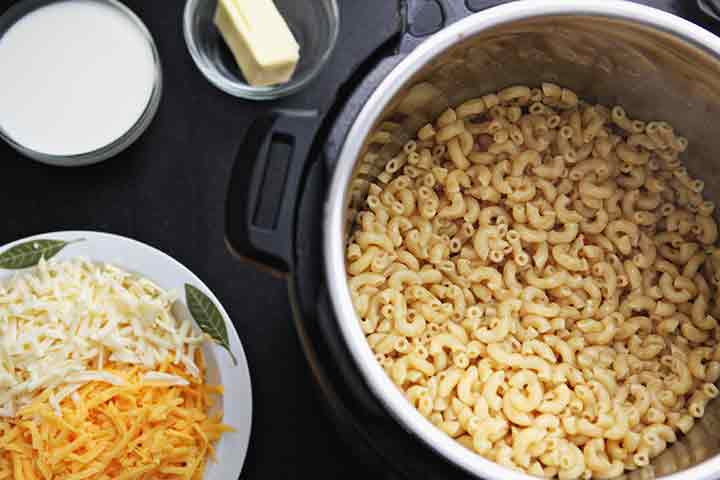 Cooked pasta sits in the Instant Pot, awaiting the dairy ingredients to make macaroni and cheese