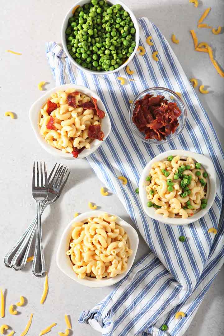 Bacon and peas are added to bowls of Instant Pot Macaroni and Cheese to give seasonal variety