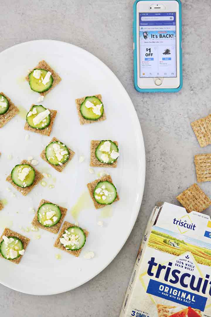 A platter of Cucumber Bites is shown with a mobile phone and TRISCUIT crackers spilling out of a box