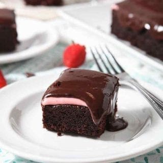 A close up of Chocolate Cake, with strawberry icing and chocolate icing