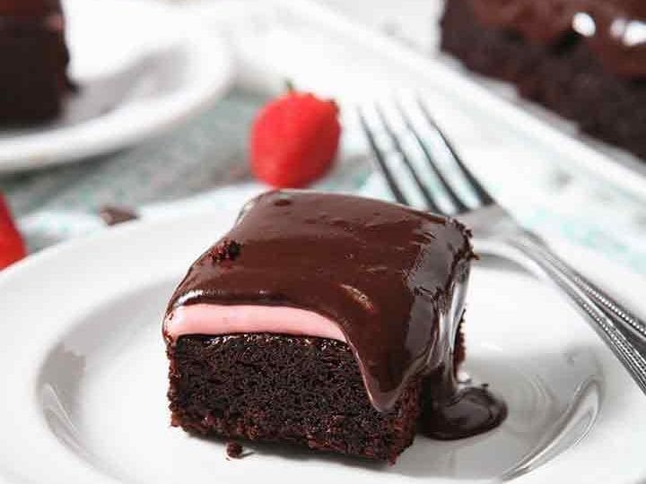 A close up of Chocolate Cake, with strawberry icing and chocolate icing