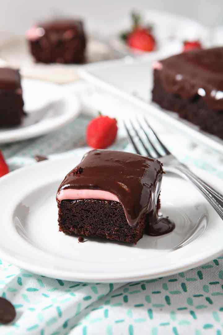 A close up of Chocolate Cake, with strawberry icing and chocolate icing