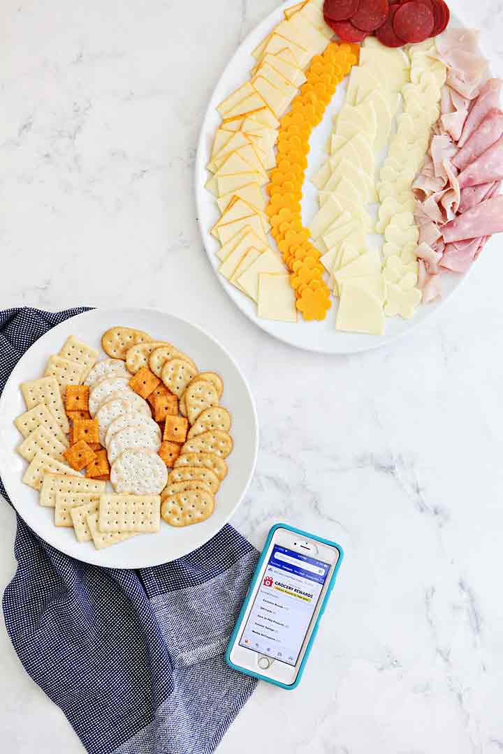 Summer snack sandwich cracker ingredients are shown from above on separate plates before being put together