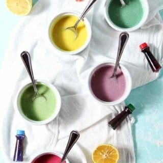 Colorfully dyed Lemon Icing in containers, ready for decorating cookies