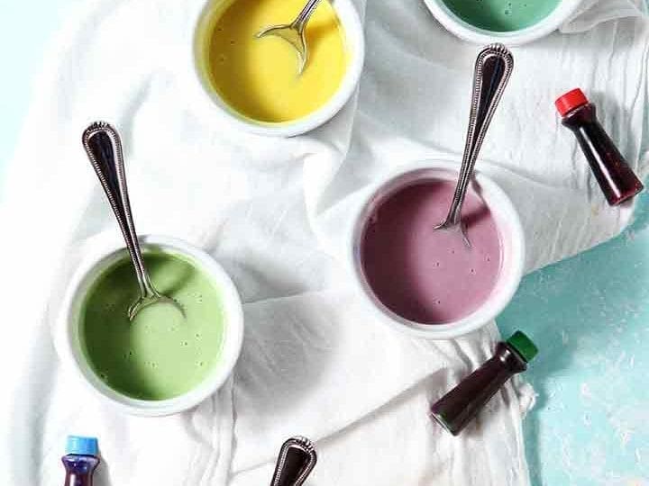 Colorfully dyed Lemon Icing in containers, ready for decorating cookies