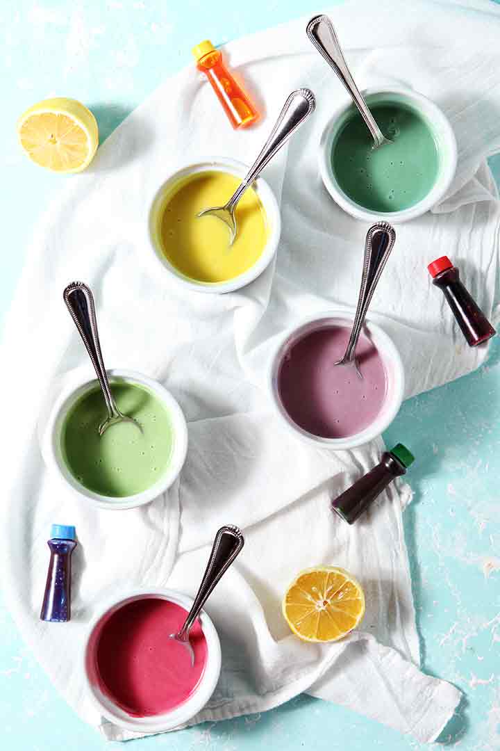 Colorfully dyed Lemon Icing in containers, ready for decorating cookies