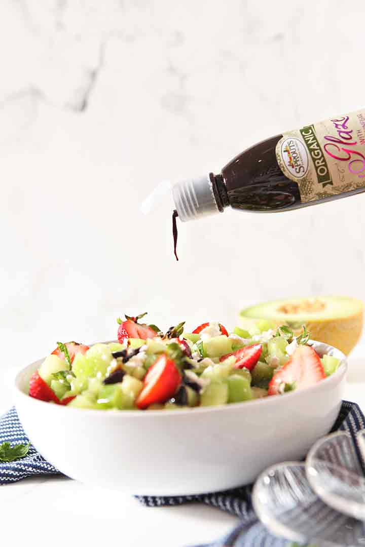 Balsamic glaze is drizzled on top of the salad