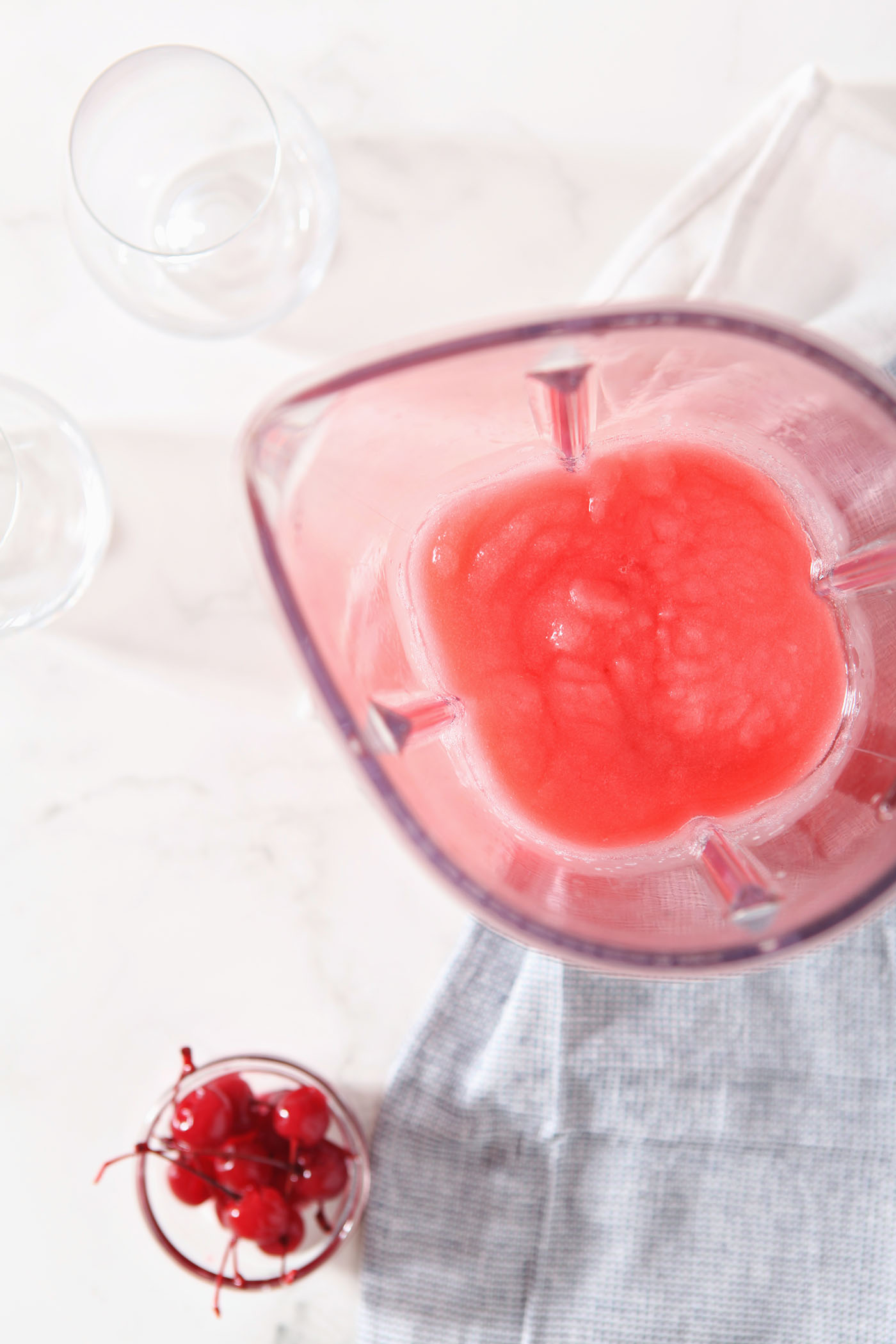 A Cherry Bourbon Slush in a blender from above before pouring into glasses