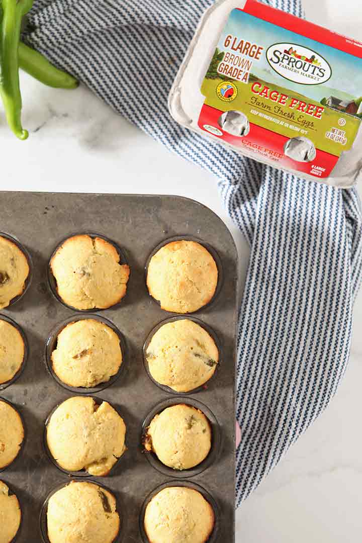 Baked cornbread muffins are shown from above, after baking