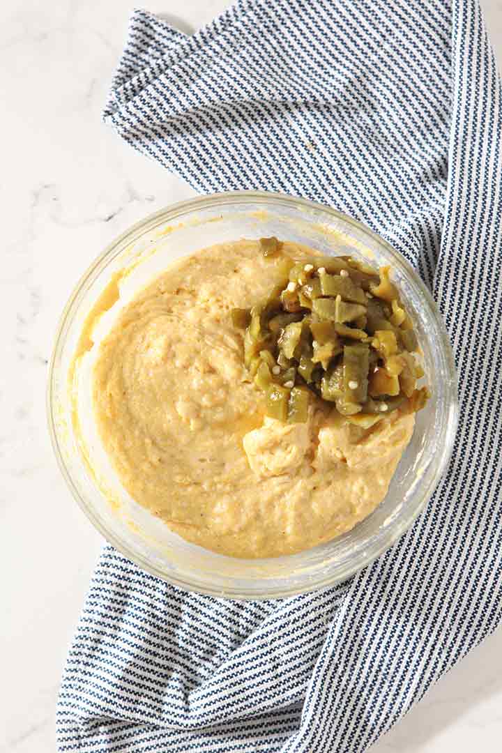 The batter, with the added Hatch chiles, is shown from above before scooping into a muffin tin