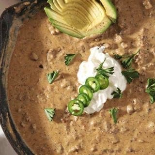 Close up of the homemade queso in a skillet with its garnishes