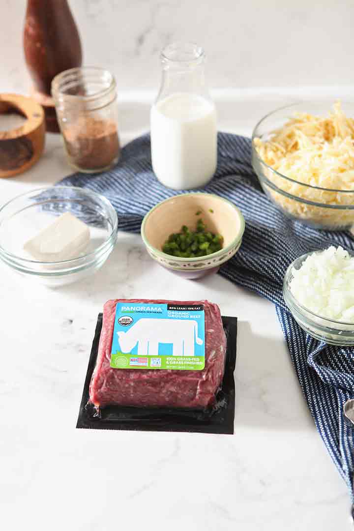 Panorama ground beef and other ingredients are laid out on a marble background