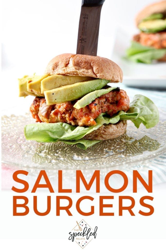 A Salmon Burger is speared with a knife, ready for eating, with Pinterest text