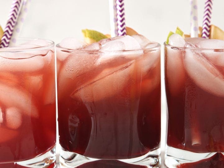 Three glasses of Individual Apple Cider Punch are garnished, from the side