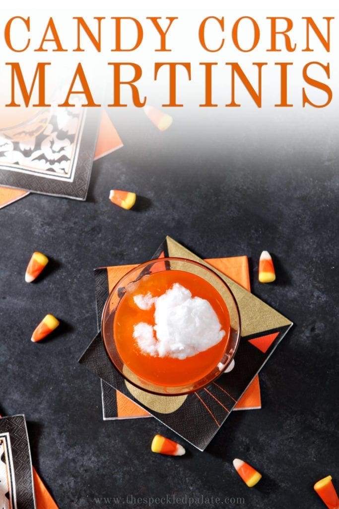 Overhead of a Candy Corn Martini, surrounded by candy corn, with Pinterest text