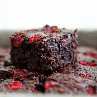 Close up of a Dr Pepper Chocolate Cherry Brownie sitting on top of other brownies in a baking pan