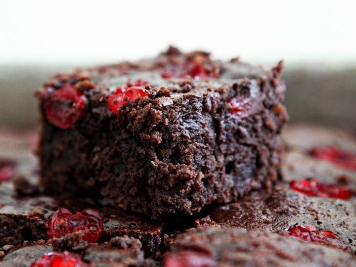 Close up of a Dr Pepper Chocolate Cherry Brownie sitting on top of other brownies in a baking pan