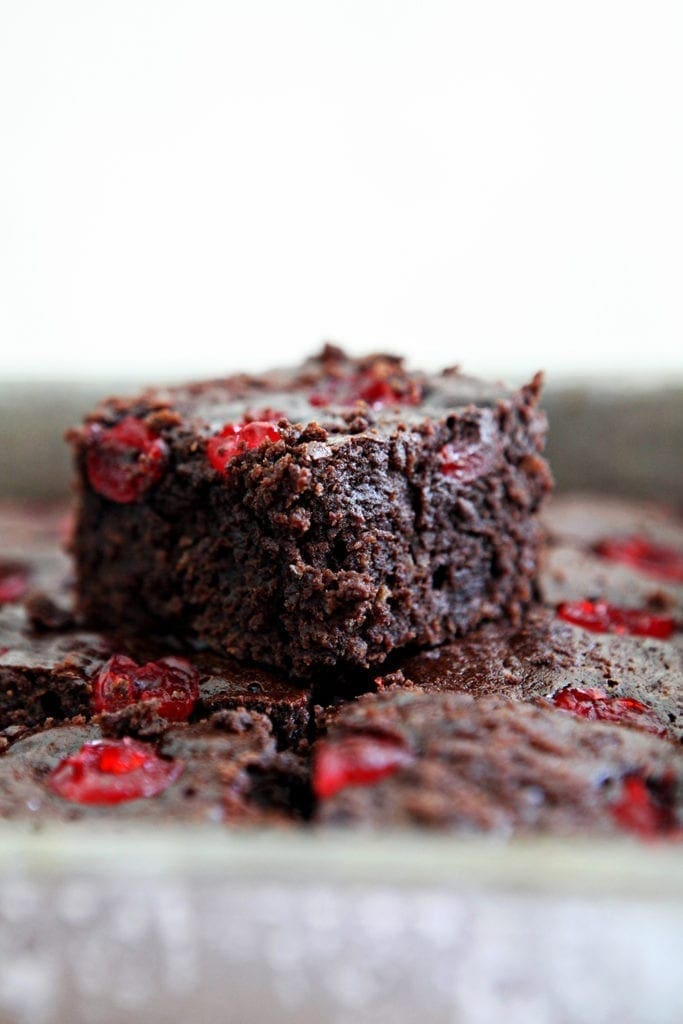 Close up of a Dr Pepper Chocolate Cherry Brownie sitting on top of other brownies in a baking pan