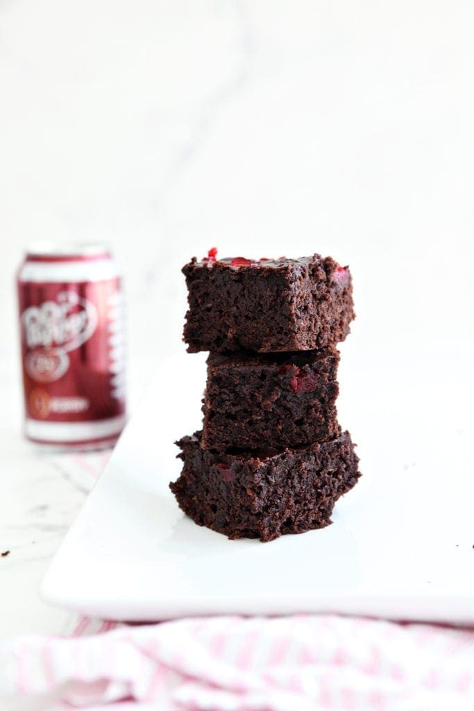 Three Dr Pepper Brownies are stacked on top of each other, before consuming