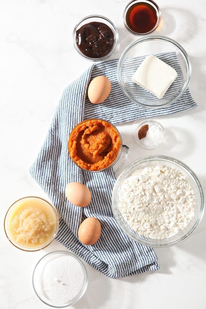 Ingredients for muffins are laid out on a marble background