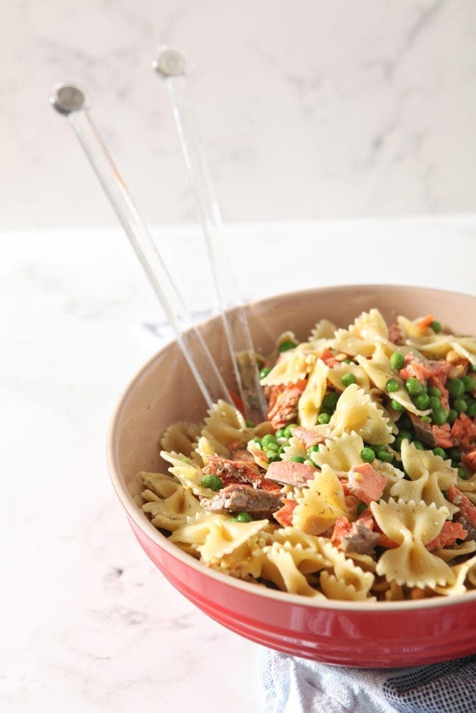 The final pasta dish is shown in a large bowl, after tossing