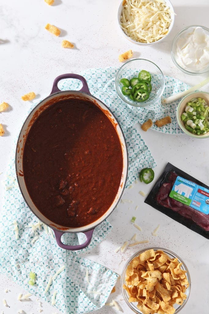 The final chili is shown in a Dutch oven, after cooking down