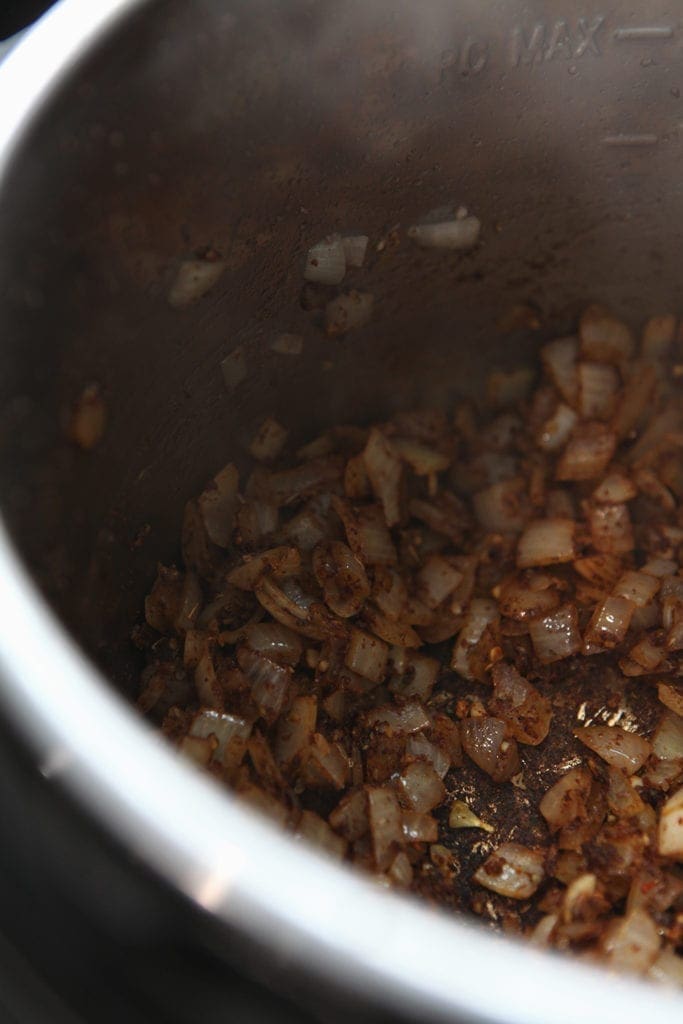 Onions and spices cook together before the pan is deglazed