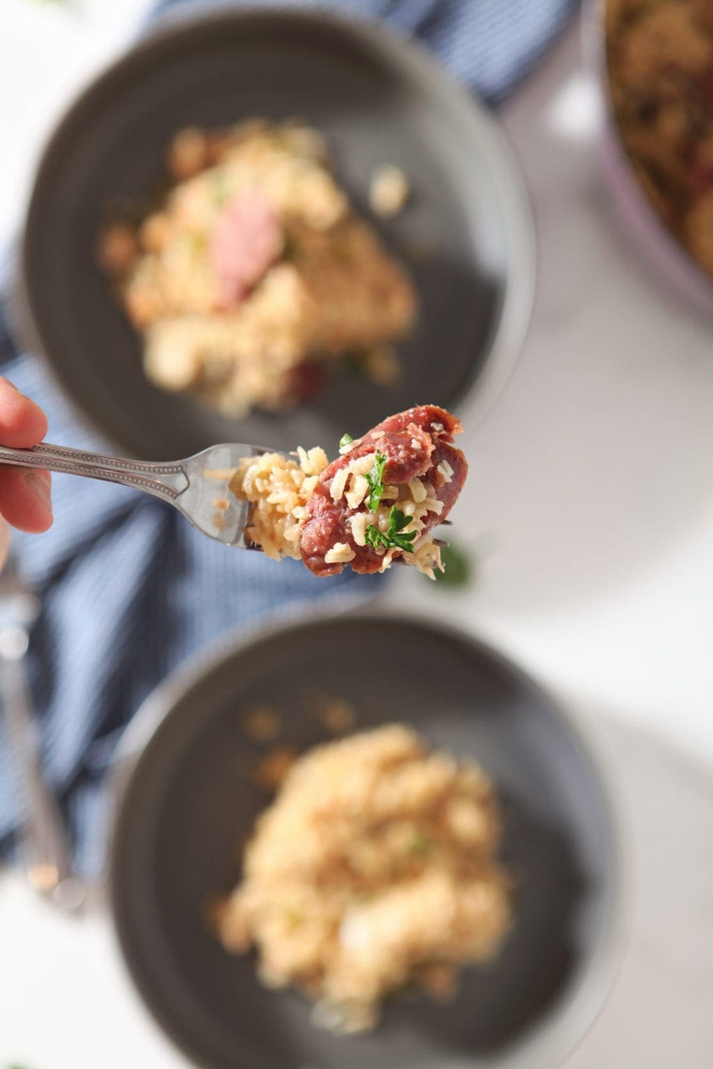 A fork holds a bite of authentic jambalaya recipe over a bowl