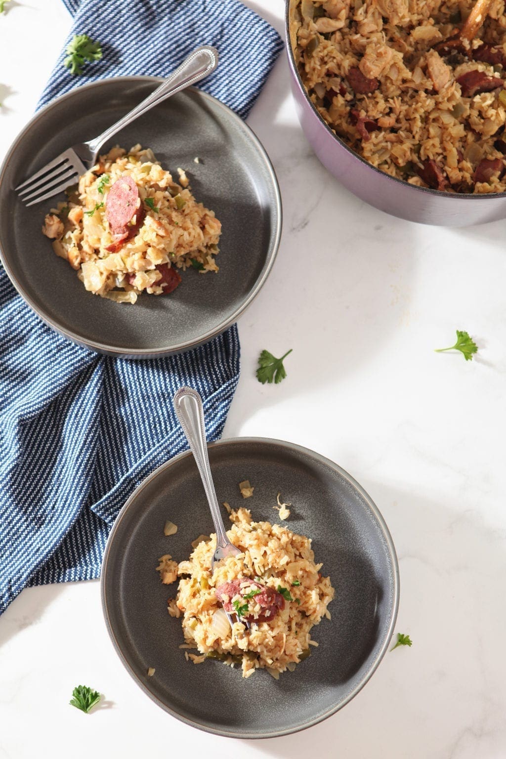 Overhead of two bowls of Chicken and Sausage Jambalaya, ready for eating