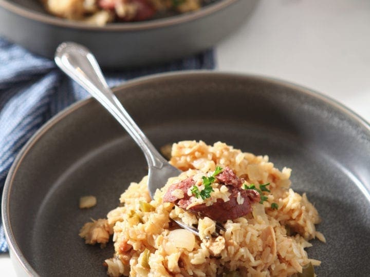 Close up of a bowl of Chicken and Sausage Jambalaya, with a fork