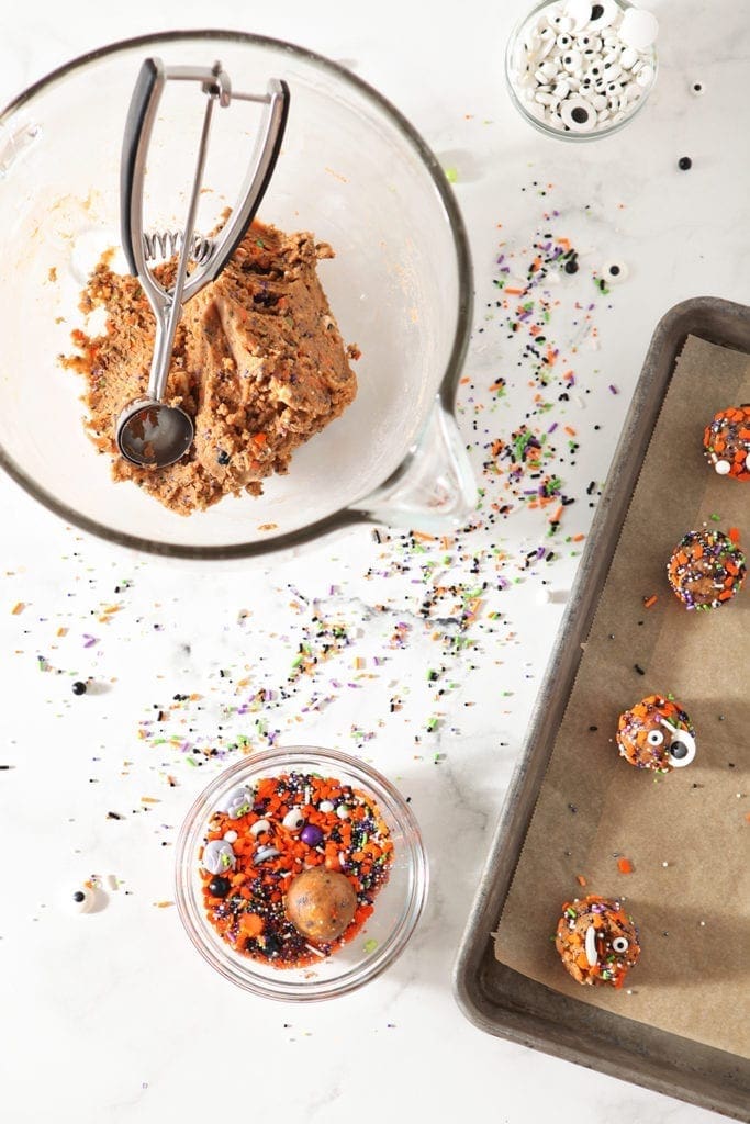 Funfetti cookie dough, shown on a baking sheet and in a bowl, before baking